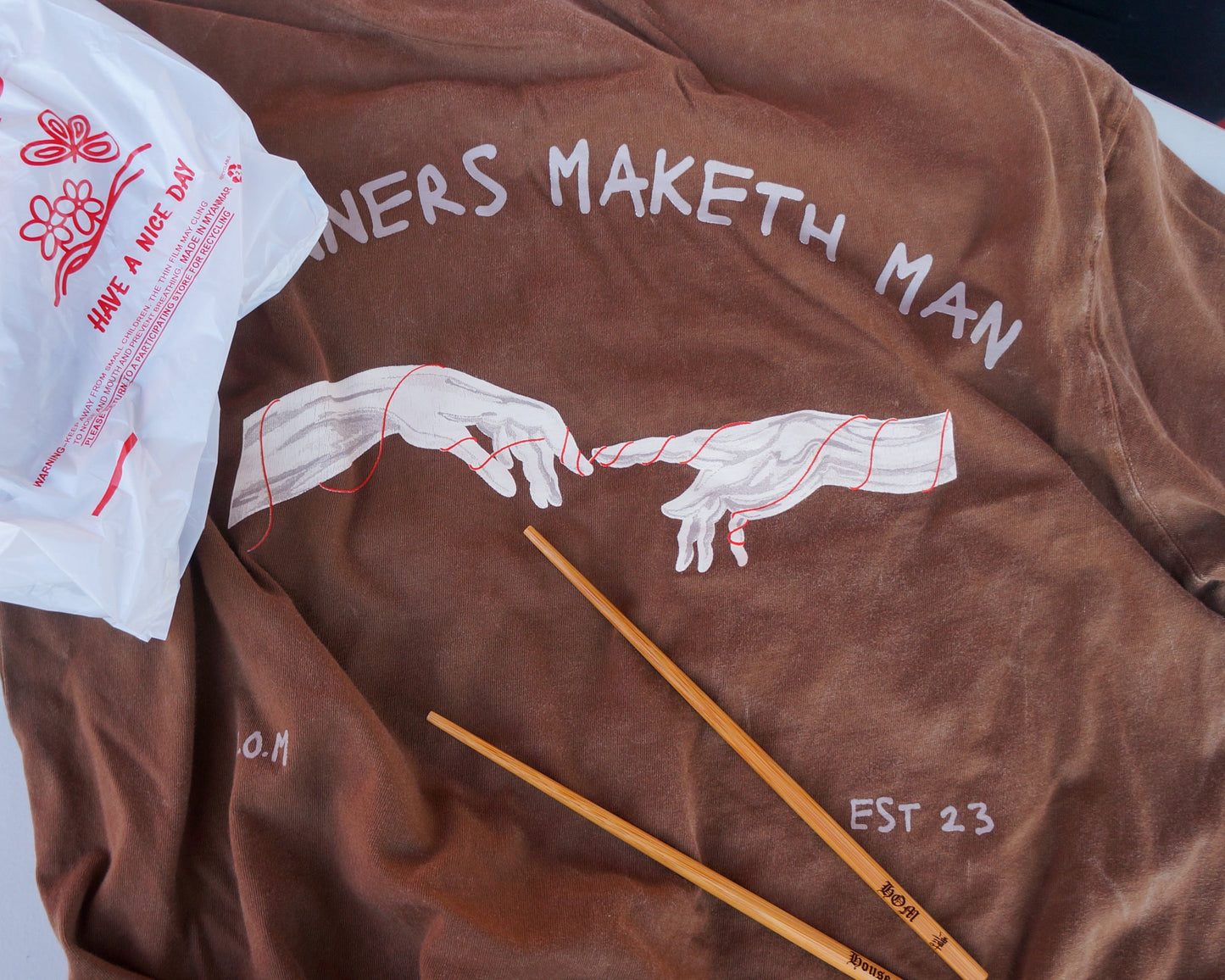 Brown shirt with graphic design on a white surface